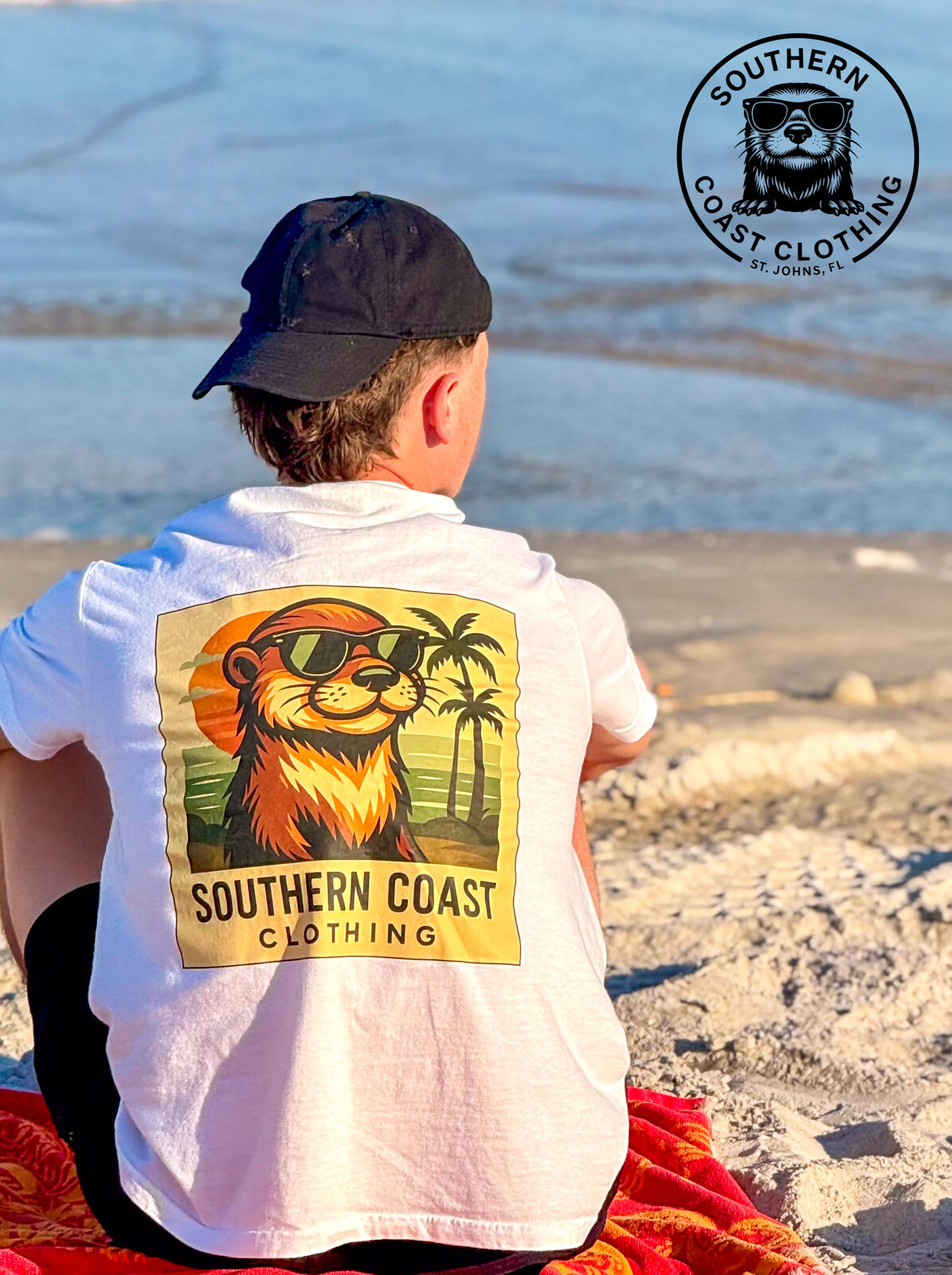 Wearing the otter-themed vintage tee on the beach